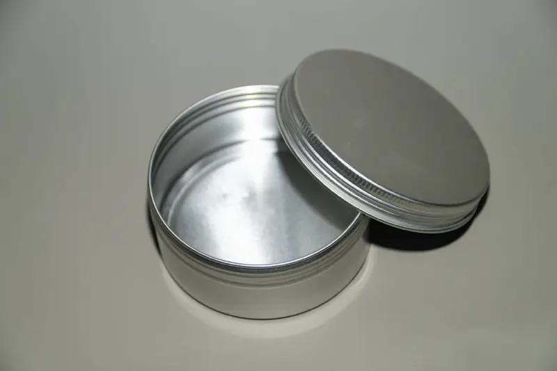 A screw top, aluminum travel tin for bar soap