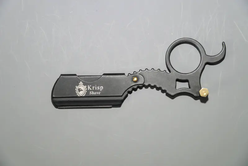 A mini straight razor with swappable blade and finger ring