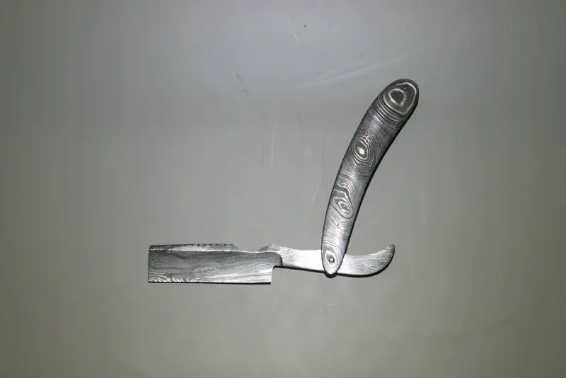 A hand made, damascus folding straight razor